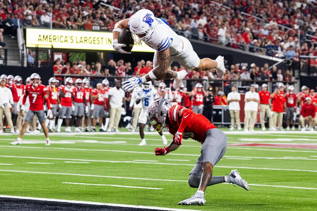 Memphis Tigers TE Hunter Tipton (0) hurdles over a UNLV Rebels player for a touchdown on Friday, August 29, 2026, at Allegiant Stadium in Las Vegas, Nevada. Memphis Tigers TE Hunter Tipton (0) hurdles over a UNLV Rebels player for a touchdown on Friday, August 29, 2026, at Allegiant Stadium in Las Vegas, Nevada.
