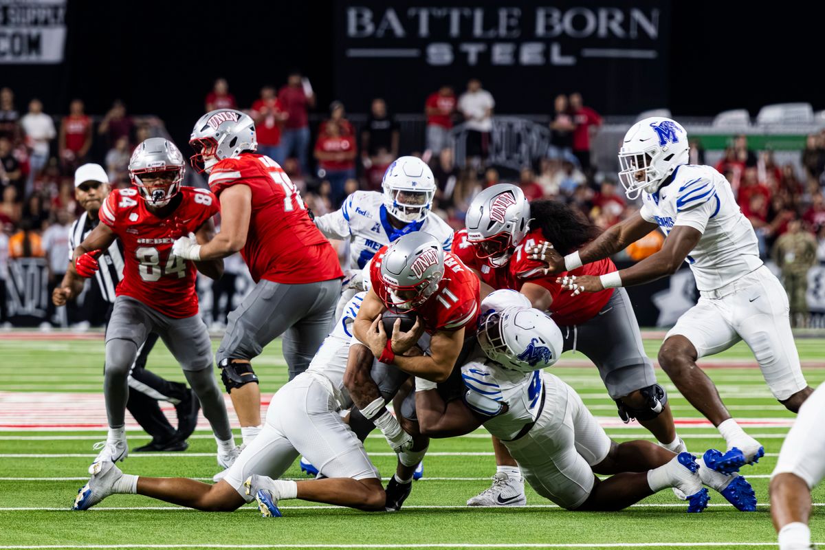 UNLV Rebels QB Jackson Arnold (11) is tackled on his rushing attempt against the Memphis Tigers on Friday, August 29, 2026, at Allegiant Stadium in Las Vegas, Nevada. UNLV Rebels QB Jackson Arnold (11) is tackled on his rushing attempt against the Memphis Tigers on Friday, August 29, 2026, at Allegiant Stadium in Las Vegas, Nevada.