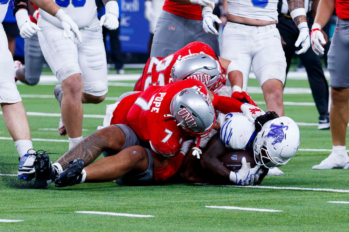 UNLV Football safety Jake Pope and UNLV Football linebacker Cam Santee stop the reciever during a non-conference college football game against the Memphis Tigers on Saturday, August 29, 2026, at Allegiant Stadium in Las Vegas, NV. UNLV Football safety Jake Pope and UNLV Football linebacker Cam Santee stop the reciever during a non-conference college football game against the Memphis Tigers on Saturday, August 29, 2026, at Allegiant Stadium in Las Vegas, NV.