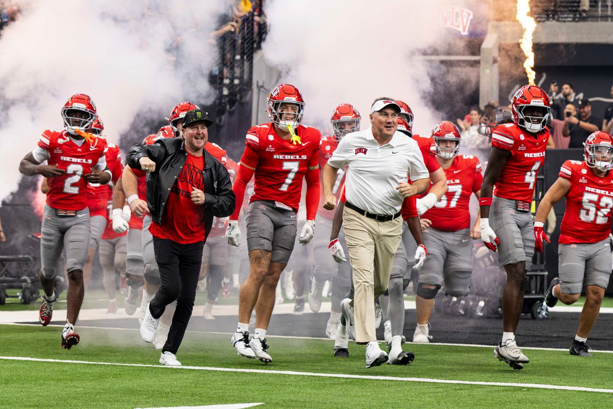 UNLV Rebels head coach Dan Mullen runs with retired NASCAR driver Kurt Busch prior to a game against the California Golden Bears on Saturday, October 03, 2026, at Allegiant Stadium in Las Vegas, Nevada. UNLV Rebels head coach Dan Mullen runs with retired NASCAR driver Kurt Busch prior to a game against the California Golden Bears on Saturday, October 03, 2026, at Allegiant Stadium in Las Vegas, Nevada.