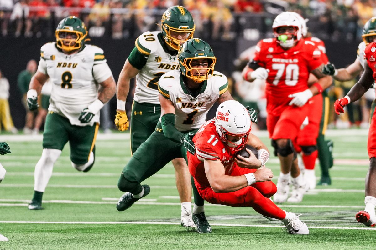UNLV quarterback Jackson Arnold (11) goes down while carrying the ball in front of North Dakota State defensive end Matthew Stenbroten (11) during second half of college football game against North Dakota State on Saturday October 10, 2026 at Allegiant Stadium in Las Vegas. UNLV quarterback Jackson Arnold (11) goes down while carrying the ball in front of North Dakota State defensive end Matthew Stenbroten (11) during second half of college football game against North Dakota State on Saturday October 10, 2026 at Allegiant Stadium in Las Vegas.