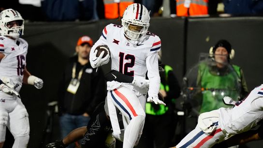 Nov 1, 2025; Boulder, Colorado, USA; Arizona Wildcats defensive back Genesis Smith (12) returns an interception in the second half against the Colorado Buffaloes at Folsom Field. 