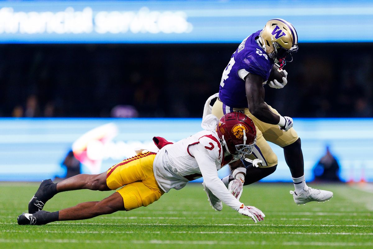USC Trojans cornerback Jaylin Smith #2 tackles Washington Huskies running back Adam Mohammed #24 during the first half at Husky Stadium on November 2, 2024 in Seattle, Washington. 