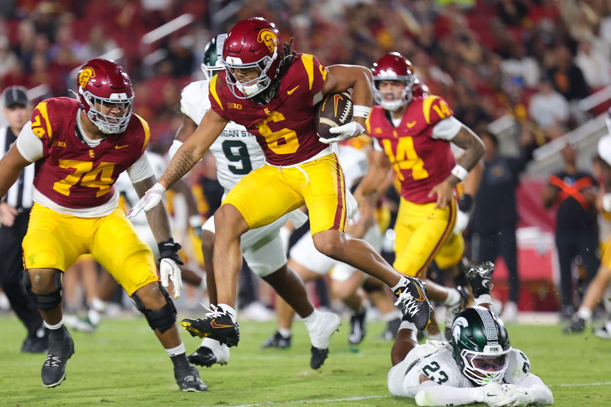 #6 Makai Lemon of USC carries the football upfield during an NCAA football game against Michigan State, September 20, 2025 in Los Angeles, CA.