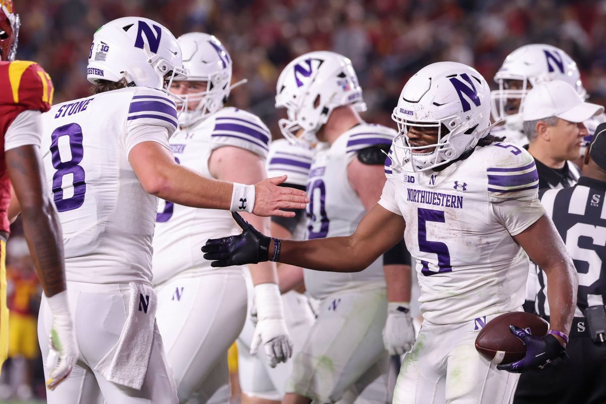 Running back Caleb Komolafe #5 and quarterback Preston Stone #8 of the Northwestern Wildcats celebrate a touchdown during an NCAA football game against the USC Trojans, Friday November 7, 2025 in Los Angeles, Calif. Running back Caleb Komolafe #5 and quarterback Preston Stone #8 of the Northwestern Wildcats celebrate a touchdown during an NCAA football game against the USC Trojans, Friday November 7, 2025 in Los Angeles, Calif.