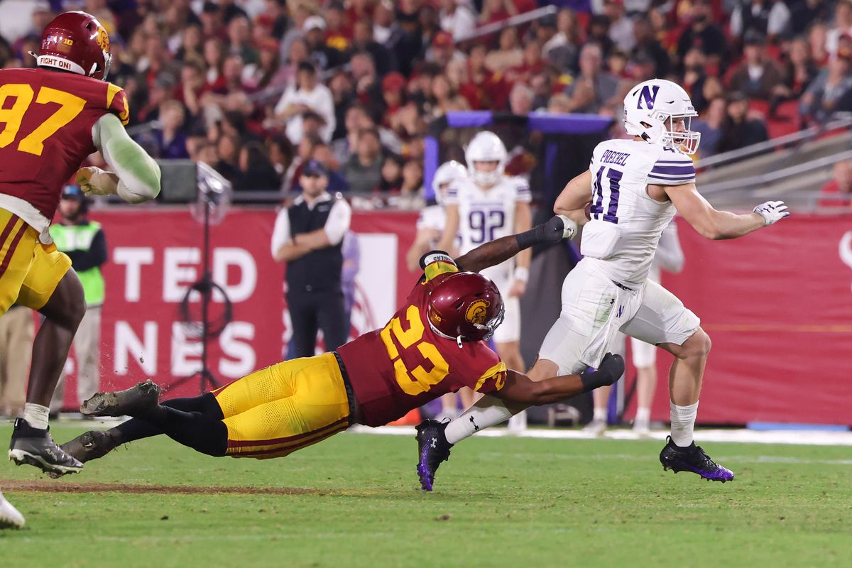 Linebacker Desman Stephens II #23 of the USC Trojans attempts to tackle tight end Robby Prequel #41 of the Northwestern Wildcats during an NCAA football game against the USC Trojans, Friday November 7, 2025 in Los Angeles, Calif. Linebacker Desman Stephens II #23 of the USC Trojans attempts to tackle tight end Robby Prequel #41 of the Northwestern Wildcats during an NCAA football game against the USC Trojans, Friday November 7, 2025 in Los Angeles, Calif.