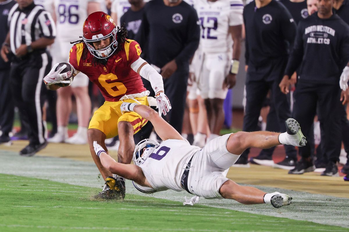 Defensive back Robert Fitzgerald #6 of the Northwestern Wildcats reaches back to tackle wide receiver Makai Lemon #6 of the USC Trojans near the sideline during an NCAA football game, Friday November 7, 2025 in Los Angeles, Calif. Defensive back Robert Fitzgerald #6 of the Northwestern Wildcats reaches back to tackle wide receiver Makai Lemon #6 of the USC Trojans near the sideline during an NCAA football game, Friday November 7, 2025 in Los Angeles, Calif.