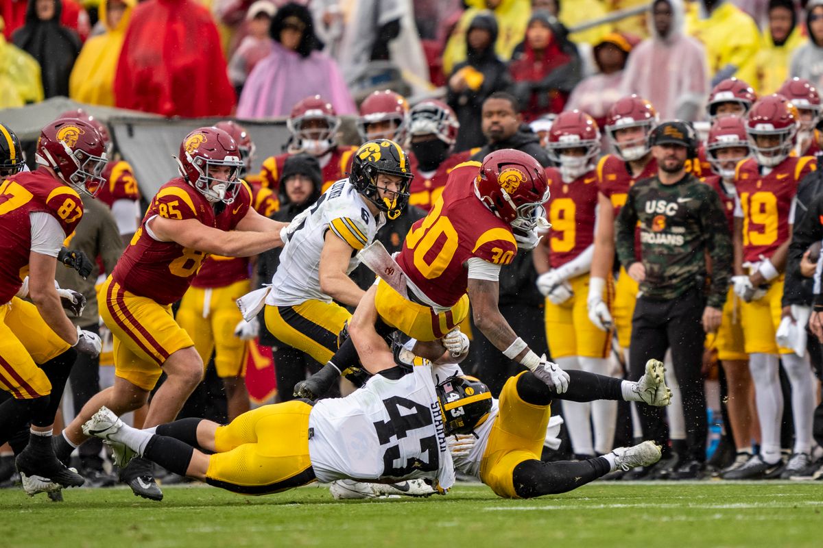 USC Trojans running back, King Miller (30) flips backwards mid-tackle during an NCAAF football game against the Iowa Hawkeyes on November 15, 2025 in Los Angeles, CA. USC Trojans running back, King Miller (30) flips backwards mid-tackle during an NCAAF football game against the Iowa Hawkeyes on November 15, 2025 in Los Angeles, CA.