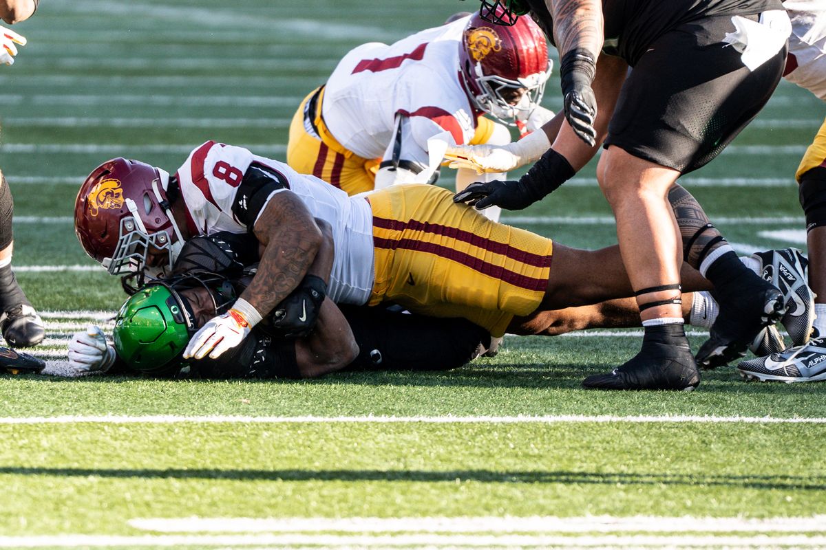 USC Trojans defensive tackle, Devan Thompkins (8) tackles the running back during an NCAAF football game against the Oregon Ducks on November 22, 2025 in Eugene, OR.