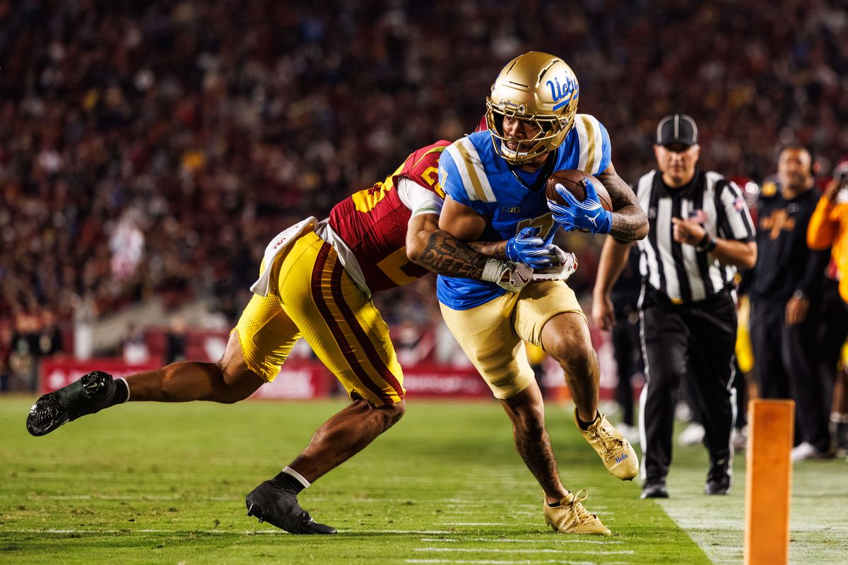UCLA Bruins wide receiver Mikey Matthews (7) attempts to run the ball in the end zone during a NCAAF game against the Southern California Trojans on November 29, 2025 in Los Angeles, CA.