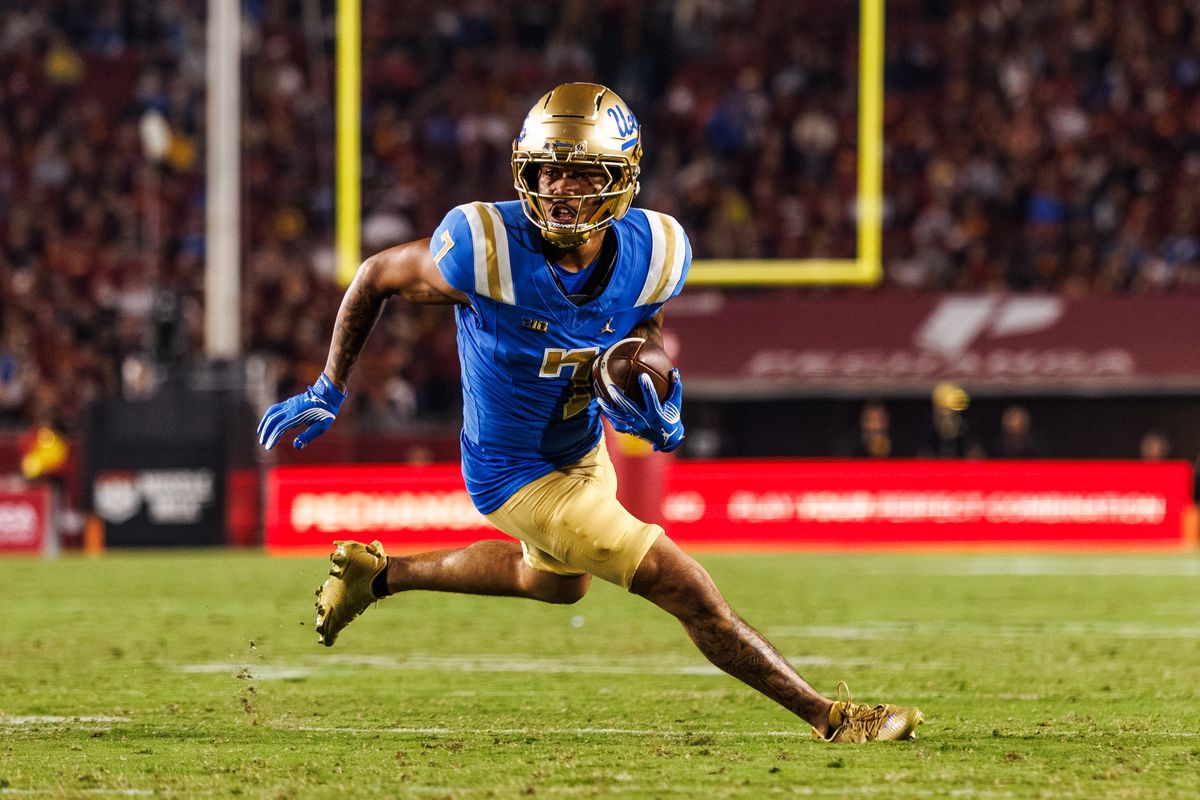 UCLA Bruins wide receiver Mikey Matthews (7) attempts to runs the ball during a NCAAF game against the Southern California Trojans on November 29, 2025 in Los Angeles, CA.
