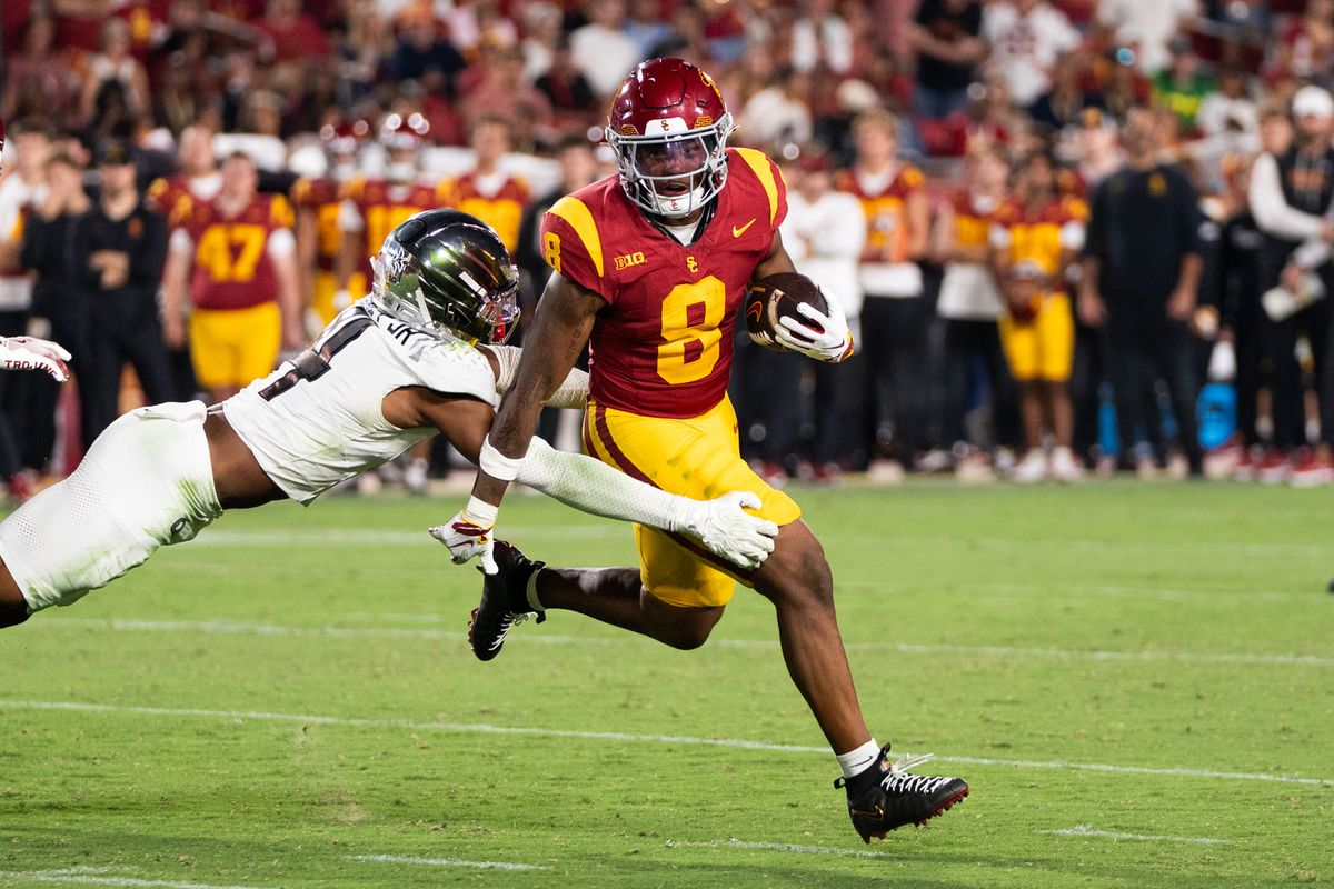 USC Trojan RB King Miller (8) shakes off his defender on his way for a first down during an NCAA football game against the Oregon Ducks on September 26, 2026 in Los Angeles, CA. USC Trojan RB King Miller (8) shakes off his defender on his way for a first down during an NCAA football game against the Oregon Ducks on September 26, 2026 in Los Angeles, CA.