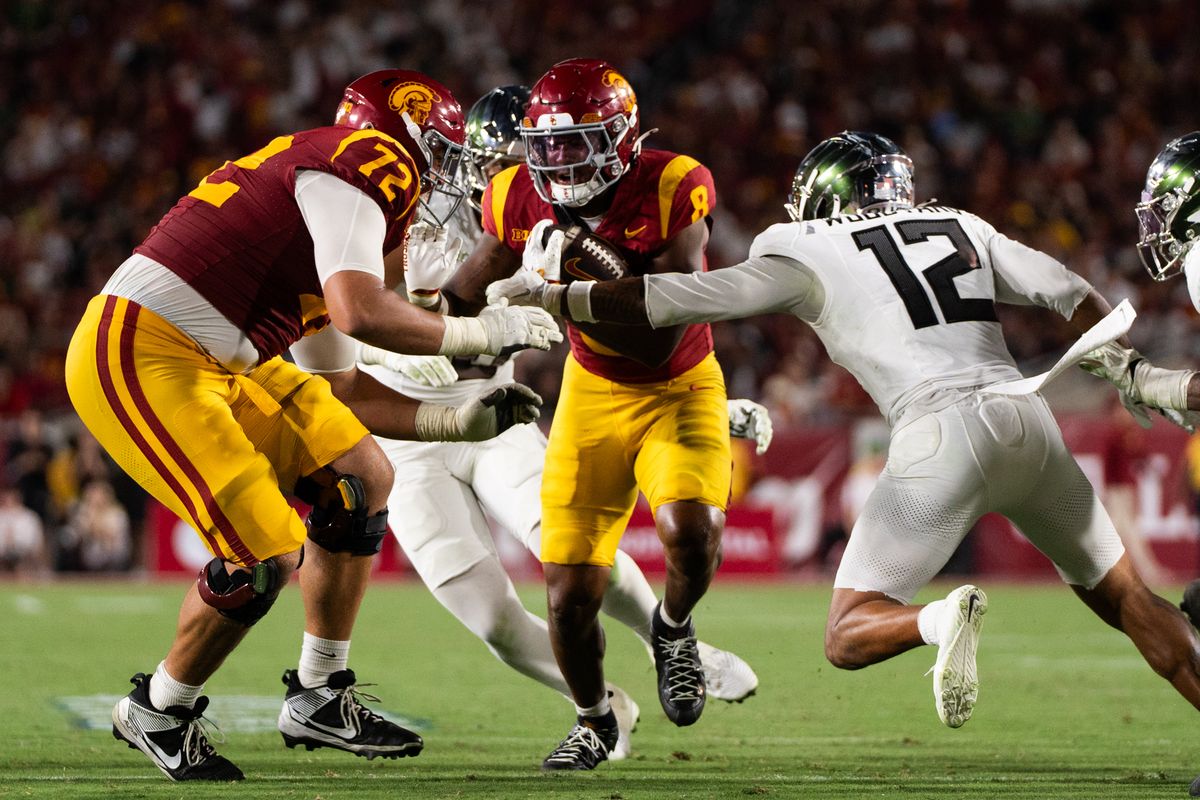 USC Trojan RB plows through the defender for. first down during an NCAA football game against the Oregon Ducks on September 26, 2026 in Los Angeles, CA. USC Trojan RB plows through the defender for. first down during an NCAA football game against the Oregon Ducks on September 26, 2026 in Los Angeles, CA.