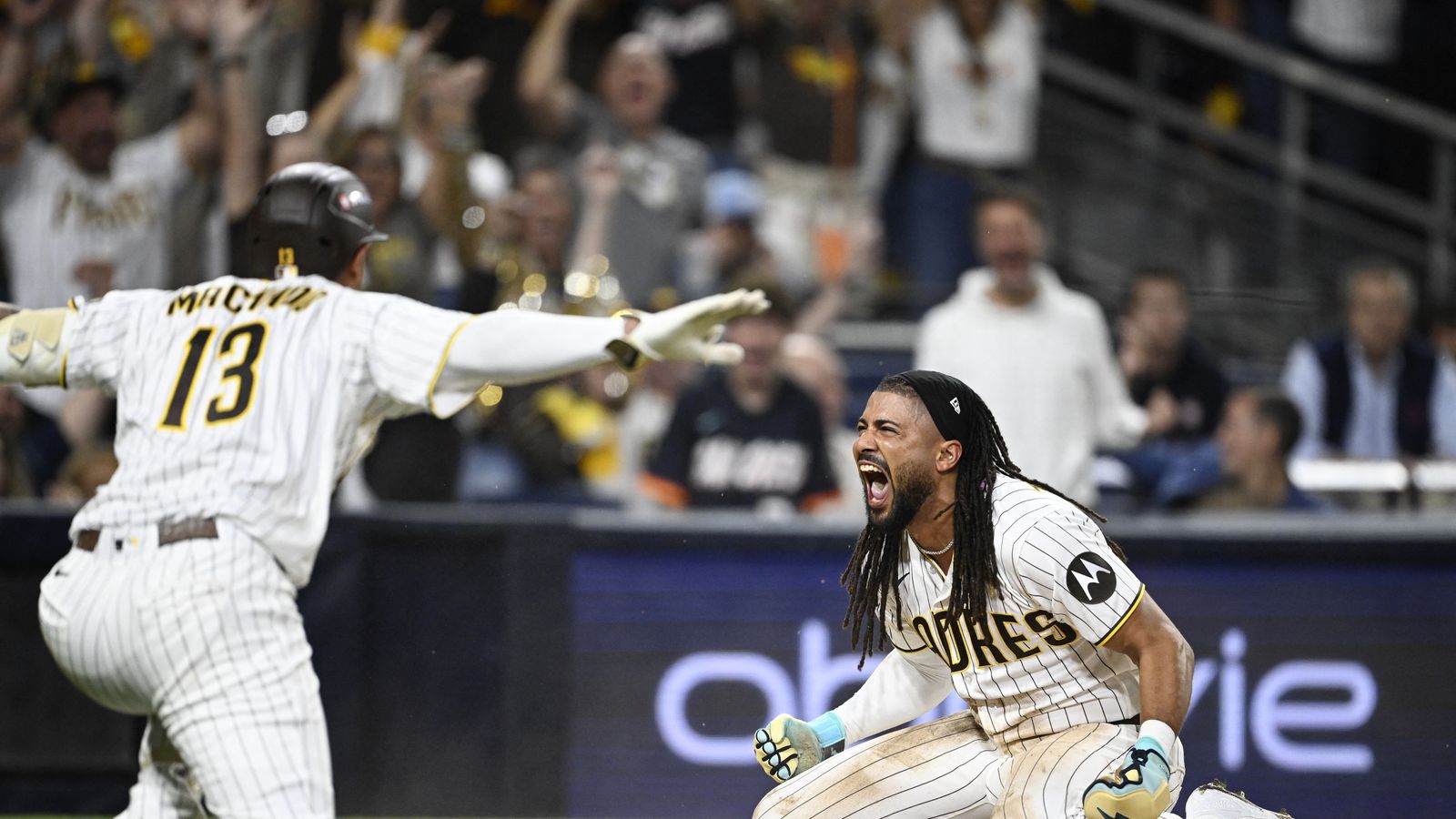 Sep 29, 2026; San Diego, California, USA; San Diego Padres outfielder Fernando Tatis Jr. (23) celebrates with third baseman Manny Machado (13) after scoring against the Chicago Cubs during the seventh inning during game one of the Wildcard round for the 2026 MLB Playoffs at Petco Park.