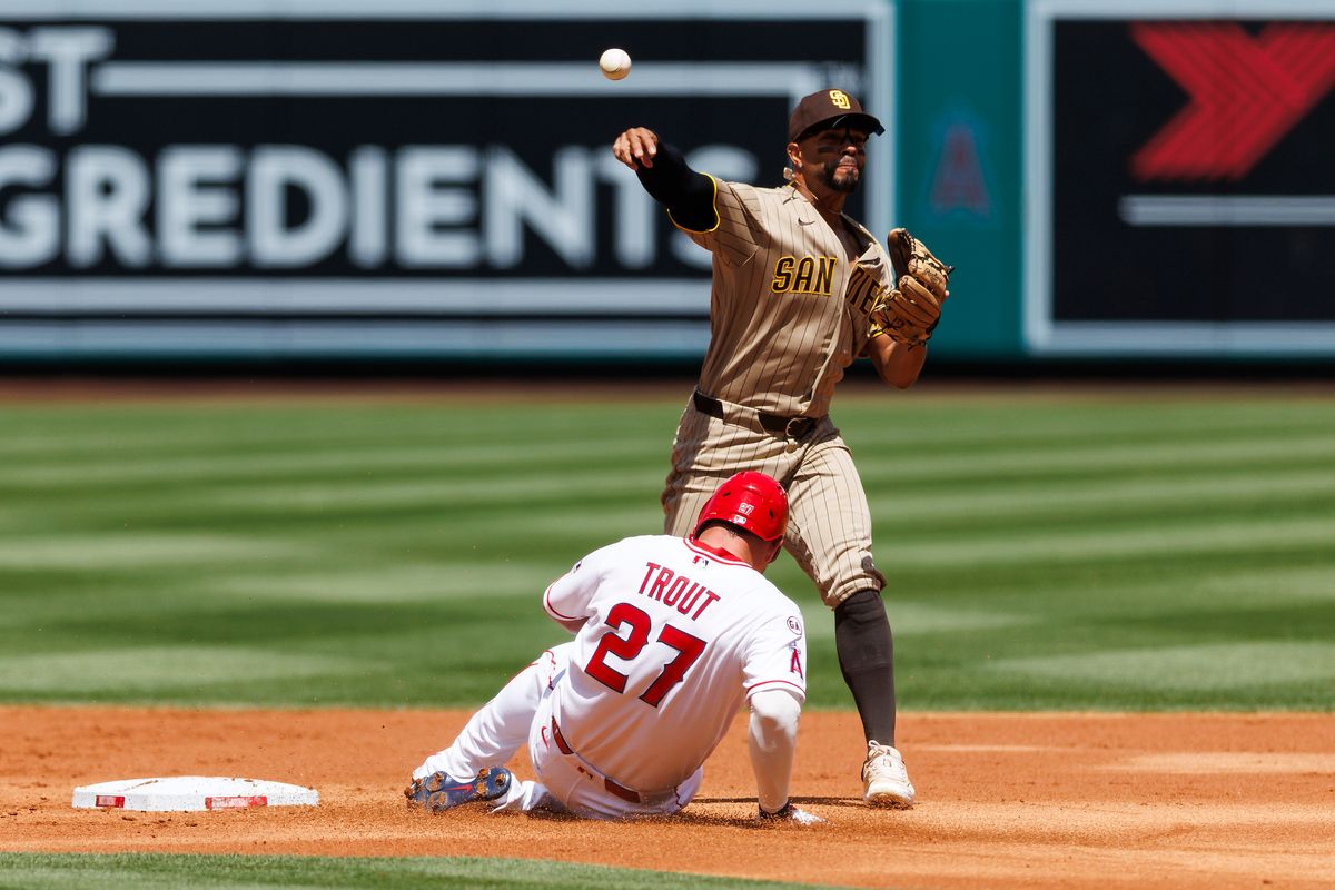 Mike Trout #27 of the Los Angeles Angels slides into second base against Xander Bogaerts #2 of the San Diego Padres during the game at Angel Stadium of Anaheim on April 19, 2026 in Anaheim, California. 