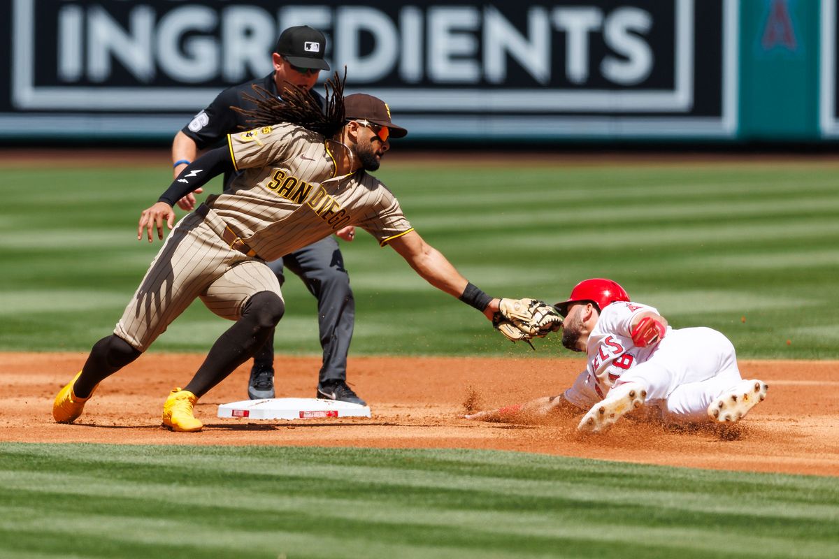 Nolan Schanuel #18 of the Los Angeles Angels slides into second base against Fernando Tatis Jr. #23 of the San Diego Padres during the game at Angel Stadium of Anaheim on April 19, 2026 in Anaheim, California.