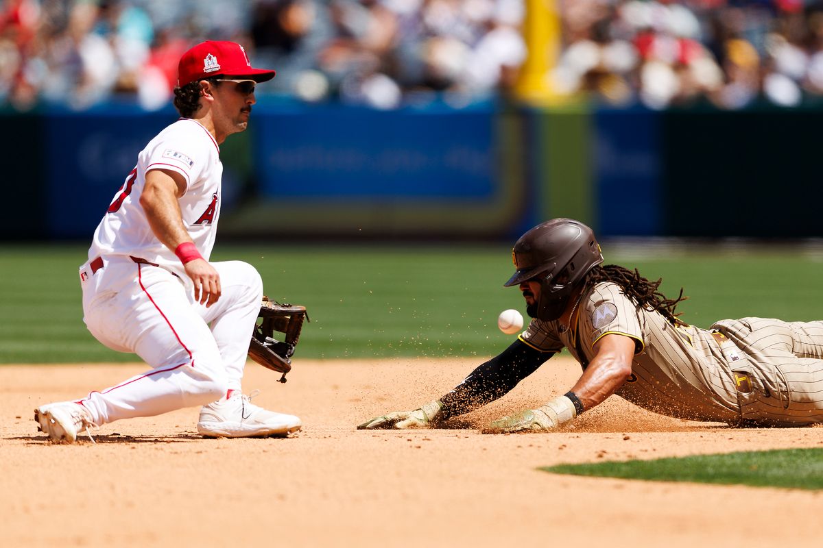 Fernando Tatis Jr. #23 of the San Diego Padres slides into second base against Adam Frazier #20 of the Los Angeles Angels during the game at Angel Stadium of Anaheim on April 19, 2026 in Anaheim, California. 