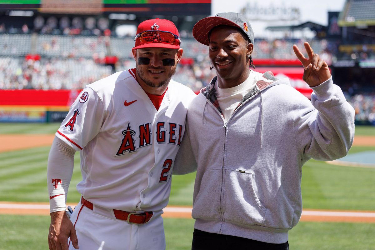 Mike Trout #27 of the Los Angeles Angels and King Miller of the USC Trojans pose for a photo before the game against the San Diego Padres at Angel Stadium of Anaheim on April 19, 2026 in Anaheim, California.