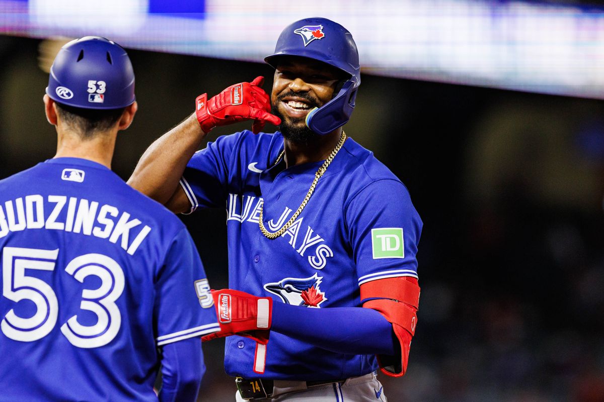 Eloy Jiménez #74 of the Toronto Blue Jays celebrates after getting on base during an MLB game against the Los Angeles Angels at Angel Stadium on April 21, 2026 in Anaheim, California.