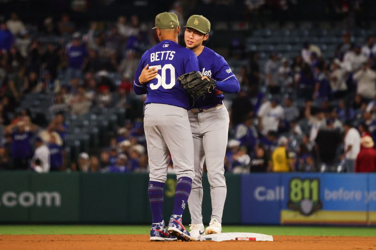 Los Angeles Dodgers infielder Mookie Betts (50) hugs Hyeseong Kim (6) after the MLB game against the Los Angeles Angels Friday May 15th, 2026 at Angel's Stadium in Anaheim, Calif.