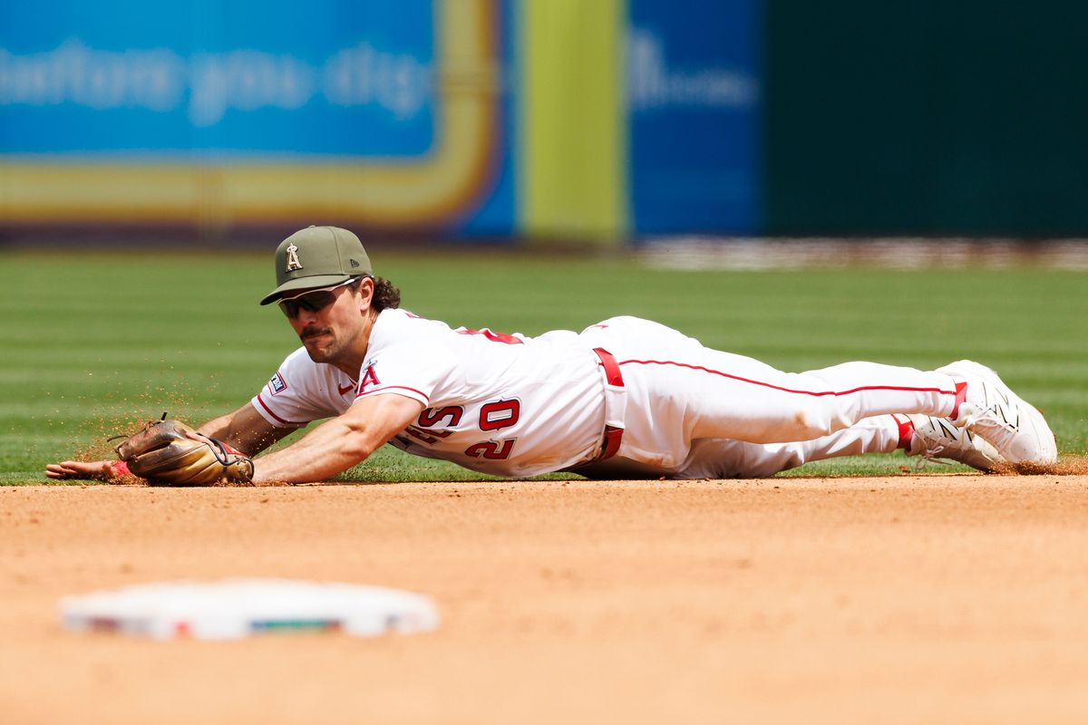 Adam Frazier #20 of the Los Angeles Angels dives for a ground ball during the game against the Los Angeles Dodgers at Angel Stadium of Anaheim on May 17, 2026 in Anaheim, California.