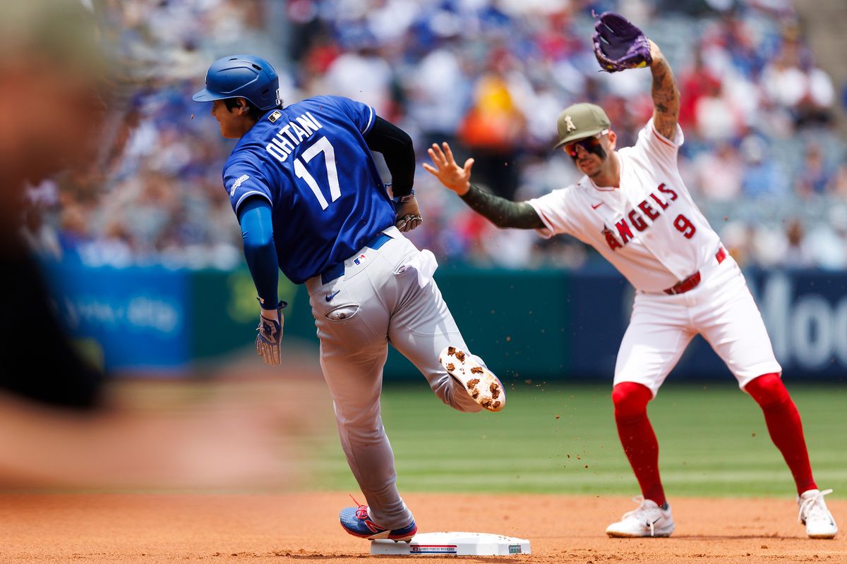 Zach Neto #9 of the Los Angeles Angels signals to Shohei Ohtani #17 of the Los Angeles Dodgers to stop after a foul ball during the game at Angel Stadium of Anaheim on May 17, 2026 in Anaheim, California. 