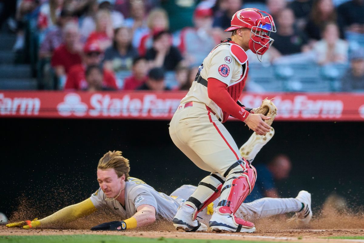 The Athletics Henry Bolte #33 slides into home base next to The Los Angeles Angels Logan O'Hoppe #14 to score a run during an MLB game against The Los Angeles Angels on May 19th, 2026 at Angels Stadium in Anaheim, California. The Athletics Henry Bolte #33 slides into home base next to The Los Angeles Angels Logan O'Hoppe #14 to score a run during an MLB game against The Los Angeles Angels on May 19th, 2026 at Angels Stadium in Anaheim, California.