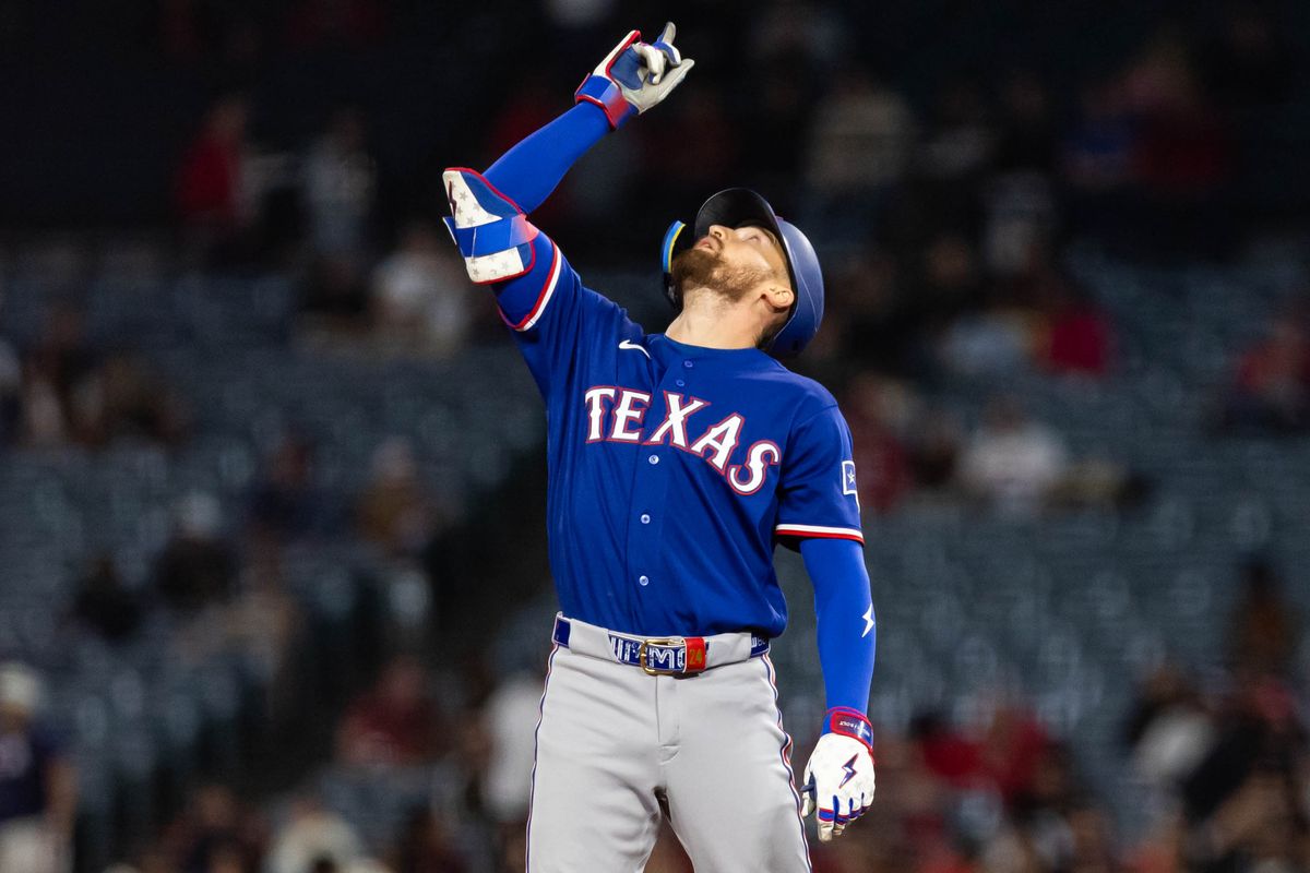 Brandon Nimmo #24 of the Texas Rangers celebrates after hitting a double during an MLB game against the Los Angeles Angels on May 23, 2026 at Angel Stadium in Anaheim, California.