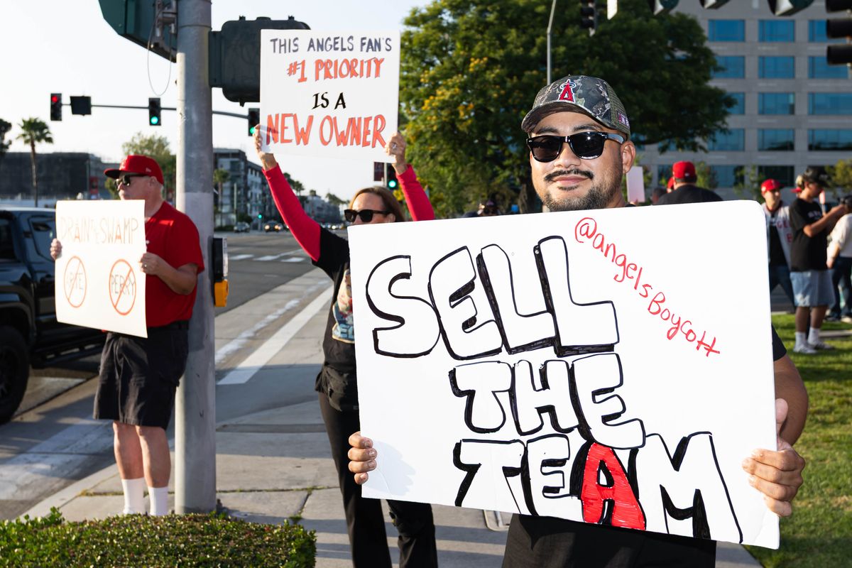 Los Angeles Angels fans protest against Arte Moreno to sell the team before an MLB game against the Texas Rangers on May 23, 2026 at Angel Stadium in Anaheim, California.