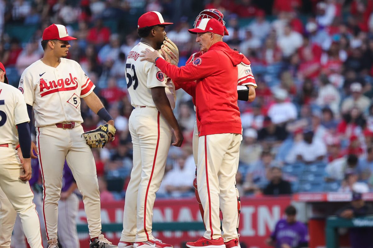 Los Angeles Angels pitcher Jose Soriano (59) meets on the mound with a coach during an MLB game against the Colorado Rockies on June 1, 2026 in Anaheim, CA.