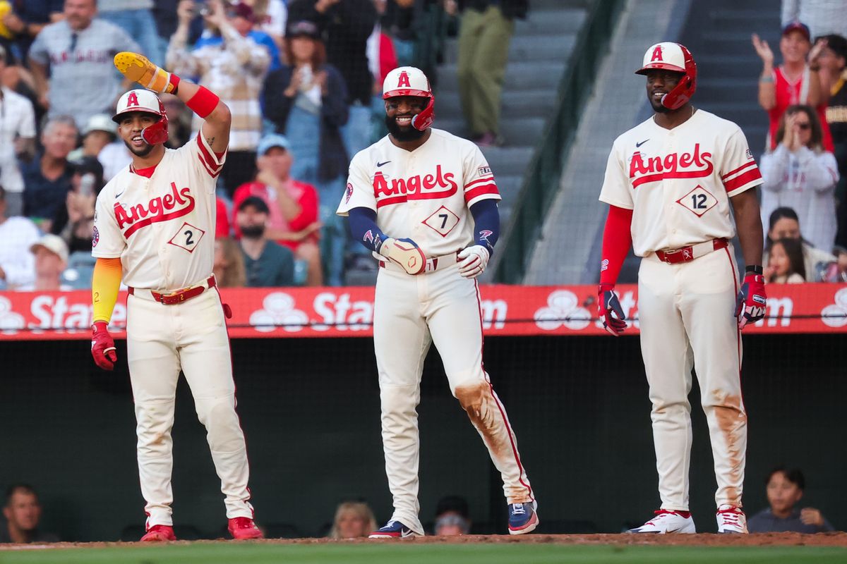Los Angeles Angels infielder Oswald Peraza (2) outfielder Jo Adell (7) and designated hitter Jorge Soler (12) celebrate a grand slam at home plate during an MLB game against the Colorado Rockies on June 1, 2026 in Anaheim, CA.