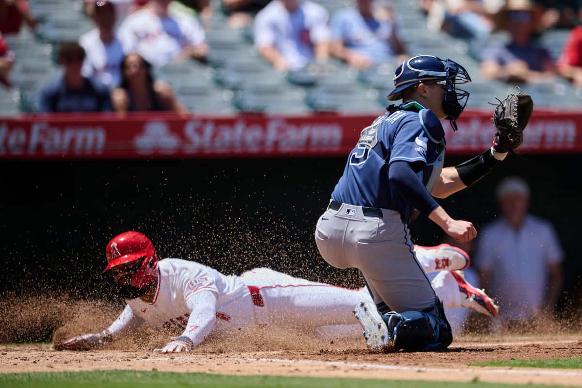 The Los Angeles Angels Jo Adell #7 slides into home base during an MLB game against The Tampa Bay Rays on June 14th, 2026 at Angel Stadium in Anaheim, California.