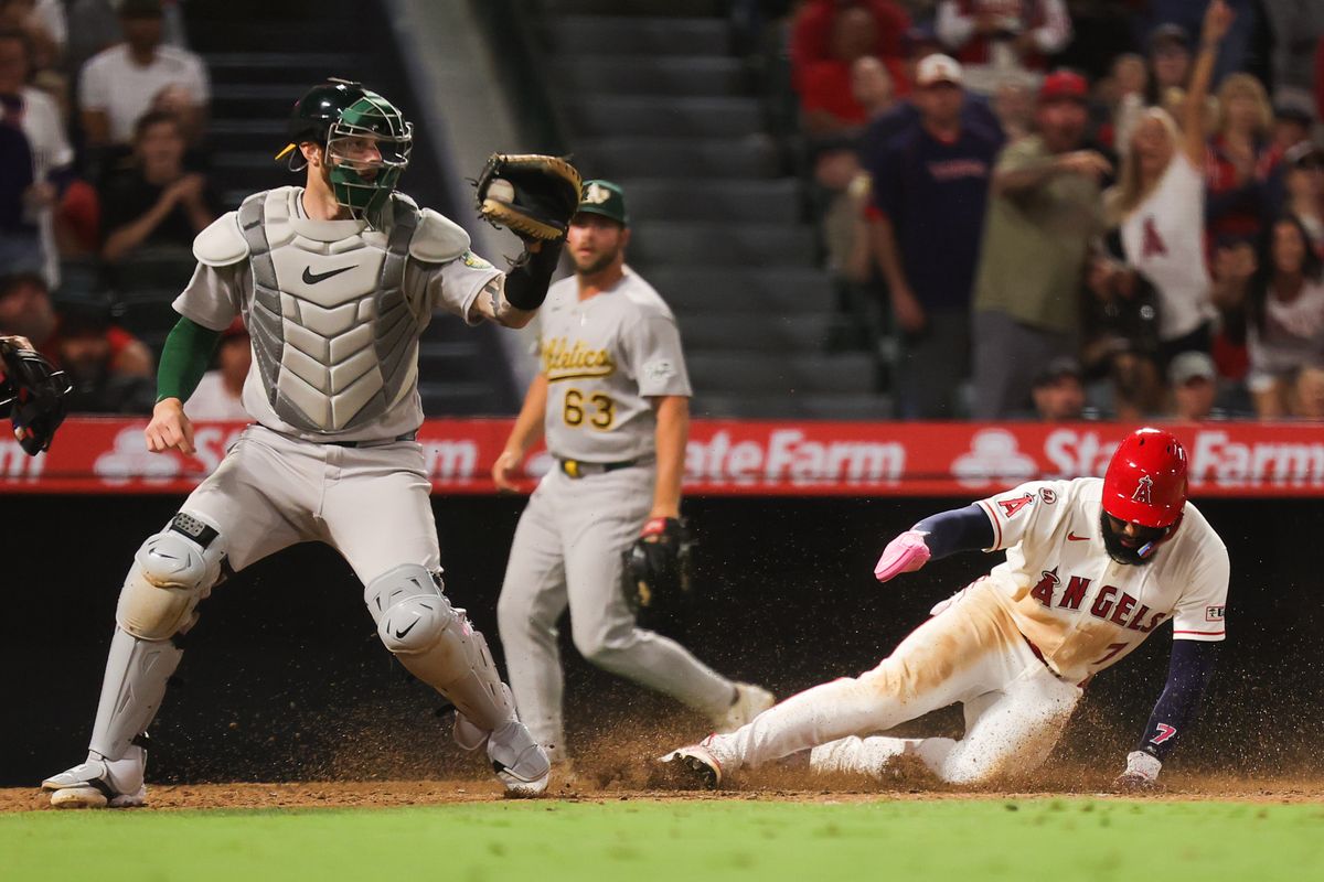 Jo Adell #7 of the Los Angeles Angels slides safely to home during an MLB game against the Las Vegas Athletics on June 27, 2026 in Anaheim, CA.