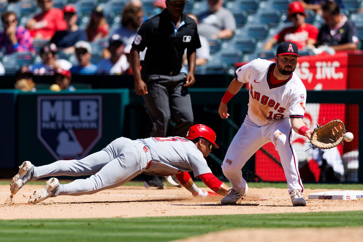Masyn Winn #0 of the St. Louis Cardinals dives back to first base against Nolan Schanuel #18 of the Los Angeles Angels during the game at Angel Stadium of Anaheim on July 22, 2026 in Anaheim, California. 