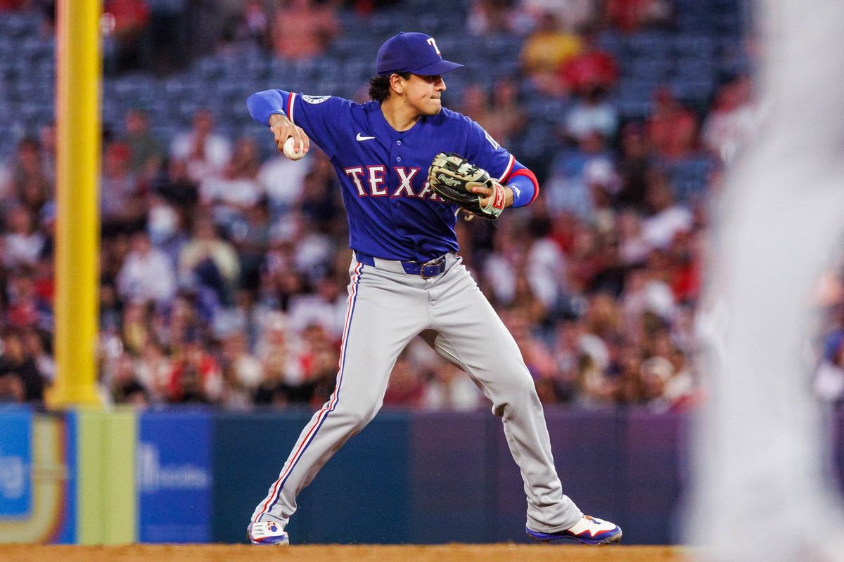 Nicky Lopez #33 of the Texas Rangers throws the ball to first base during an MLB game against the Los Angeles Angels on August 12, 2026 at Angel Stadium in Anaheim, California.