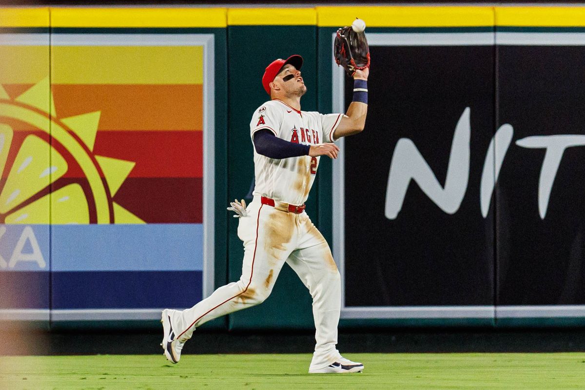 Mike Trout #27 of the Los Angeles Angels catches a fly ball during an MLB game against the Texas Rangers on August 12, 2026 at Angel Stadium in Anaheim, California.