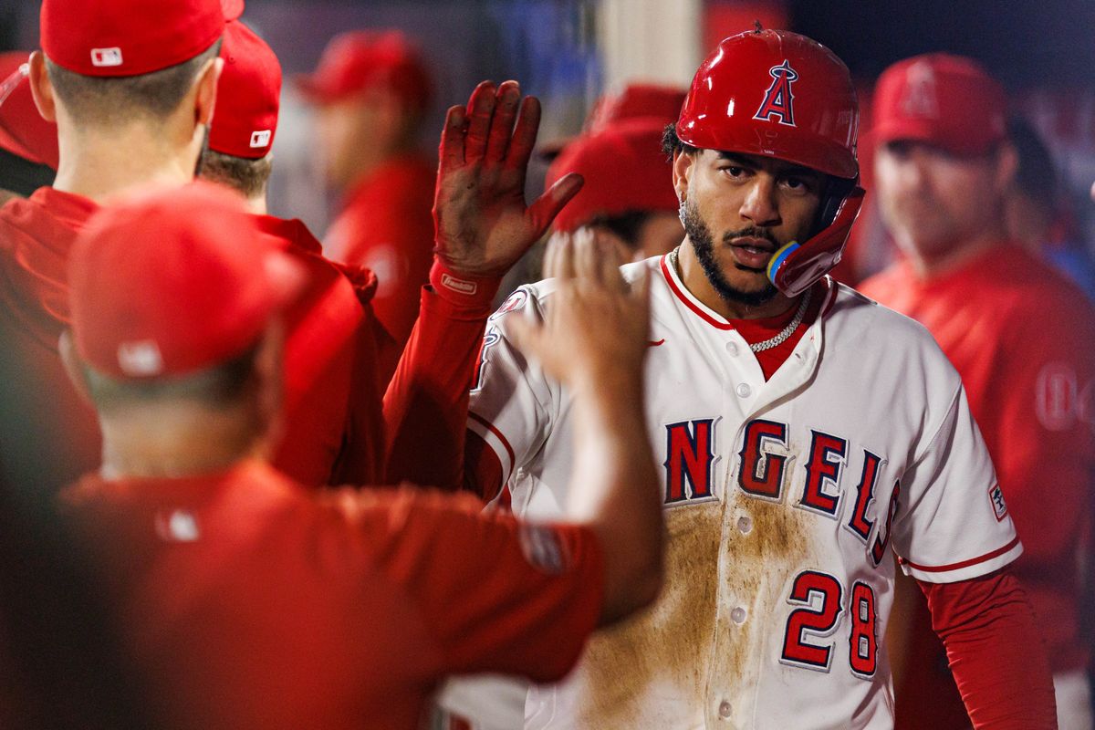 Jose Siri #28 of the Los Angeles Angels is welcomed back to the dugout during an MLB game against the Texas Rangers on August 12, 2026 at Angel Stadium in Anaheim, California.
