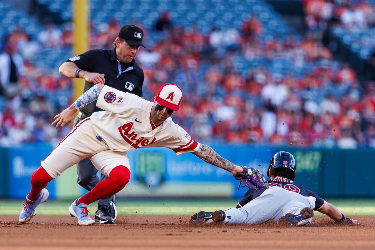 Zach Neto #9 of the Los Angeles Angels tags out Steven Kwan #38 of the Cleveland Guardians during an MLB game against the Cleveland Guardians on August 24, 2026 at Angel Stadium in Anaheim, California.