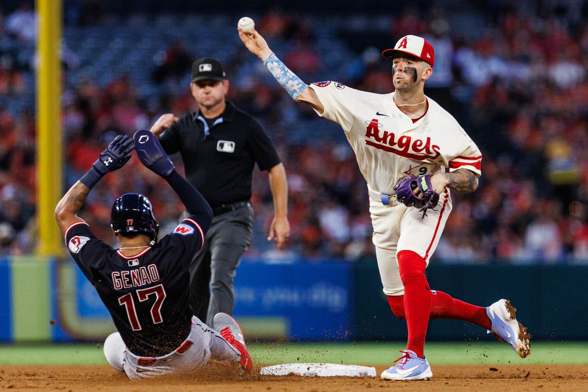 Zach Neto #9 of the Los Angeles Angels throws to first base to complete the double play during an MLB game against the Cleveland Guardians on August 24, 2026 at Angel Stadium in Anaheim, California.