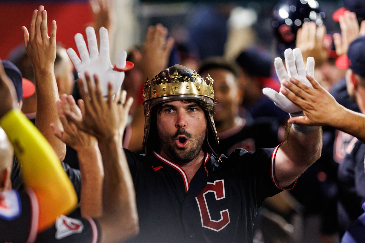 Austin Hedges #27 of the Cleveland Guardians is welcomed after hitting a 2 run home run during an MLB game against the Los Angeles Angels on August 24, 2026 at Angel Stadium in Anaheim, California.