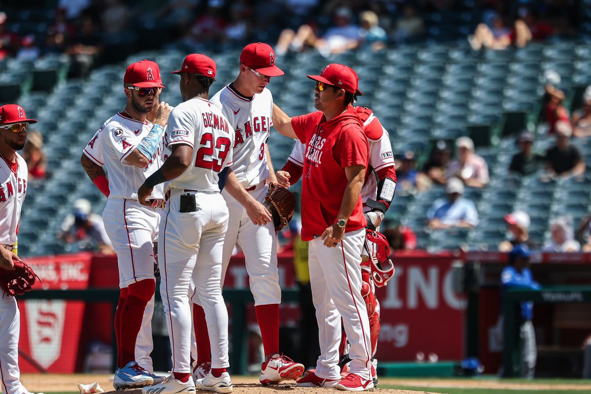 Angels coaching staff and infielders huddle at the mound to make a pitching change in the top of the sixth inning against the Kansas City Royals at Angel Stadium. Angels coaching staff and infielders huddle at the mound to make a pitching change in the top of the sixth inning against the Kansas City Royals at Angel Stadium.