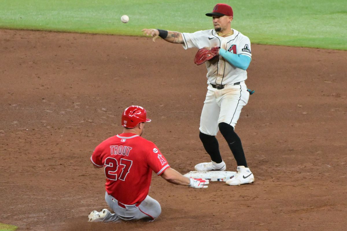 Arizona Diamondbacks first baseman Ildemaro Vargas (6) turns a double play on Los Angeles Angels center fielder Mike Trout (27) in the sixth inning at Chase Field. 