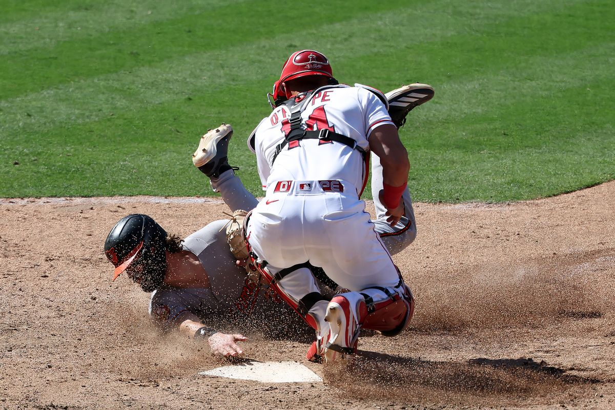 Baltimore Orioles third baseman Blaze Alexander (23) is tagged out by Los Angeles Angels catcher Logan O'Hoppe (14) during the 10th inning at Angel Stadium.
