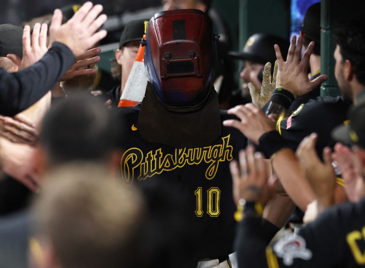 Sep 5, 2026; Pittsburgh, Pennsylvania, USA; Pittsburgh Pirates left fielder Bryan Reynolds (10) celebrates his solo home run while wearing a welder's hood in the dugout against the Los Angeles Angels during the eighth inning at PNC Park. Mandatory Credit: Charles LeClaire-Imagn Images Sep 5, 2026; Pittsburgh, Pennsylvania, USA; Pittsburgh Pirates left fielder Bryan Reynolds (10) celebrates his solo home run while wearing a welder's hood in the dugout against the Los Angeles Angels during the eighth inning at PNC Park. Mandatory Credit: Charles LeClaire-Imagn Images