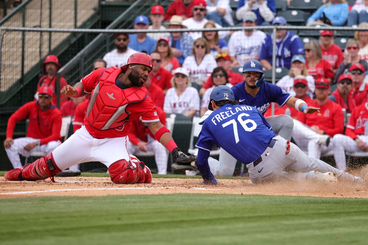 Los Angeles Dodgers' Alex Freeland (76) slides into home plate during a spring training baseball game against the Los Angeles Angels Wednesday March 5th, 2025 at Tempe Diablo Stadium in Tempe, Ariz.