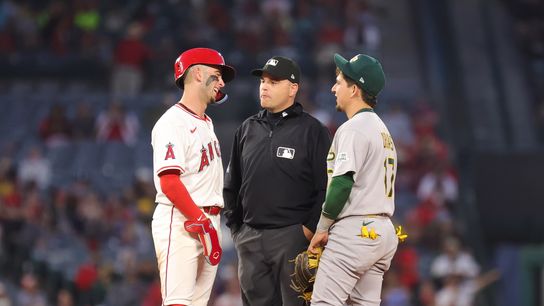 Los Angeles Angels infielder #9 Zach Neto and Las Vegas Athletics infielder #17 Luis Urias talk during a pause in action in Anaheim, CA.