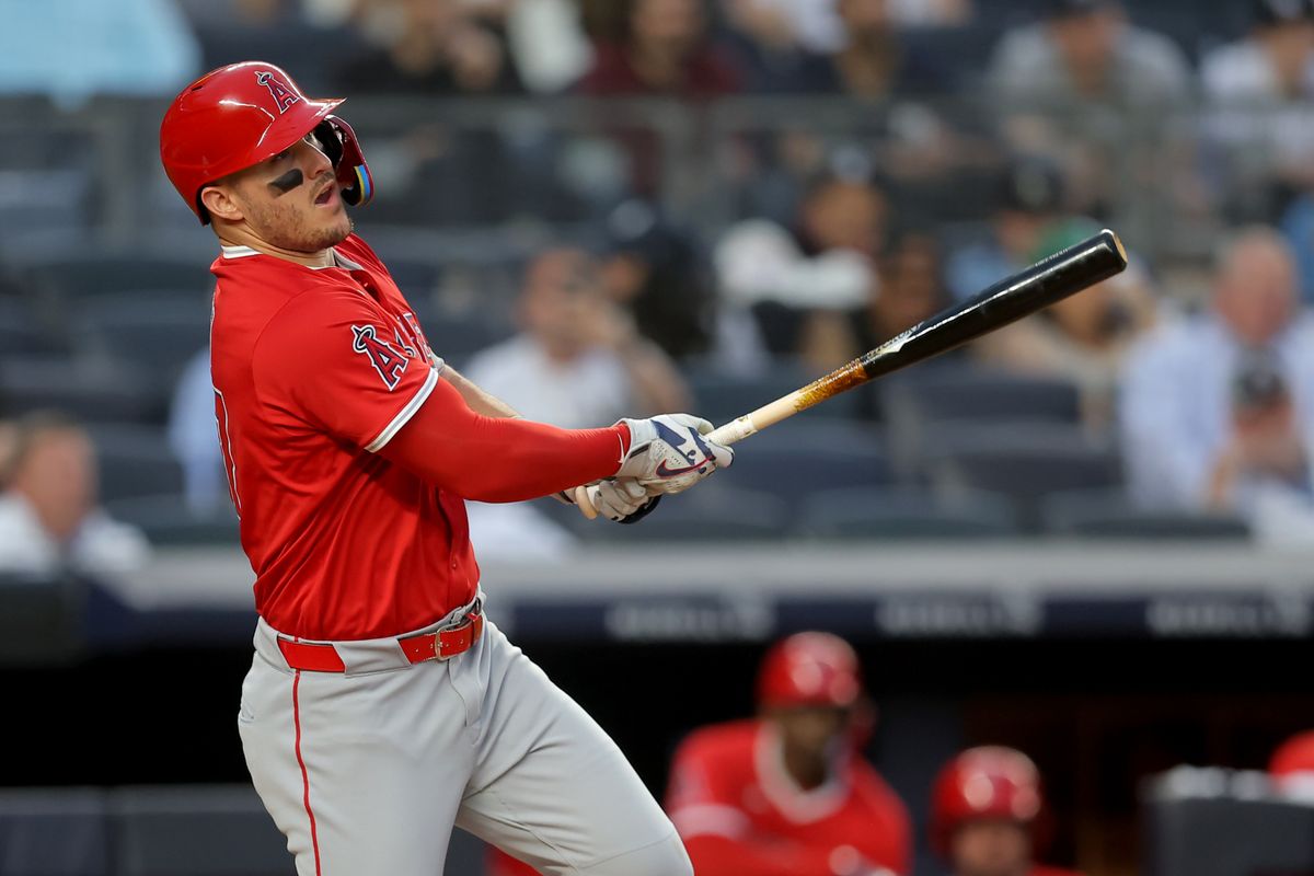 Los Angeles Angels designated hitter Mike Trout (27) follows through on a single against the New York Yankees during the third inning at Yankee Stadium.