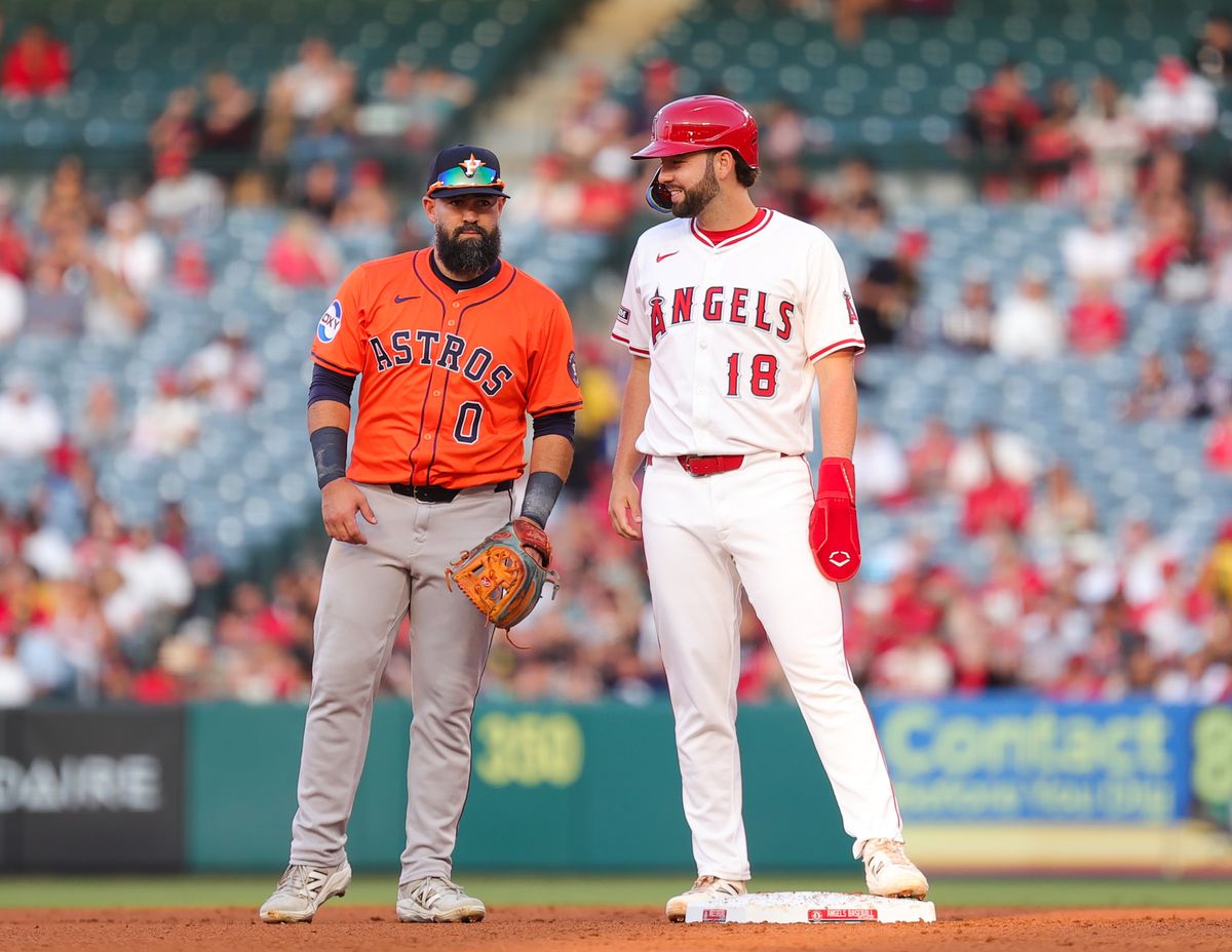 Los Angeles Angels infielder #18 Nolan Schanuel talks with Houston Astros infielder #0 Luis Gillorme during an MLB game  in Anaheim, CA.