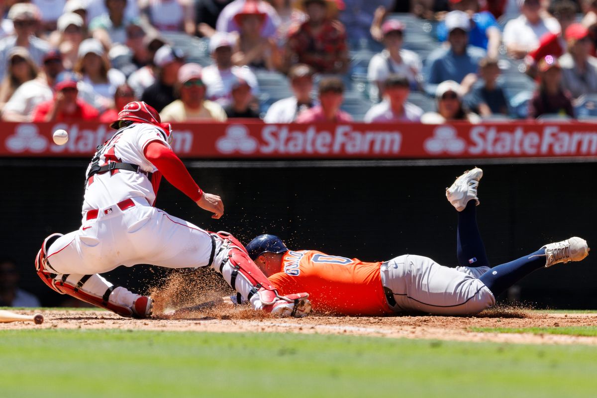 Luis Guillorme #0 of the Houston Astros slides into home plate abasing Logan O’Hoppe #14 of the Los Angeles Angels during the game at Angel Stadium of Anaheim on June 22, 2025 in Anaheim, California. 