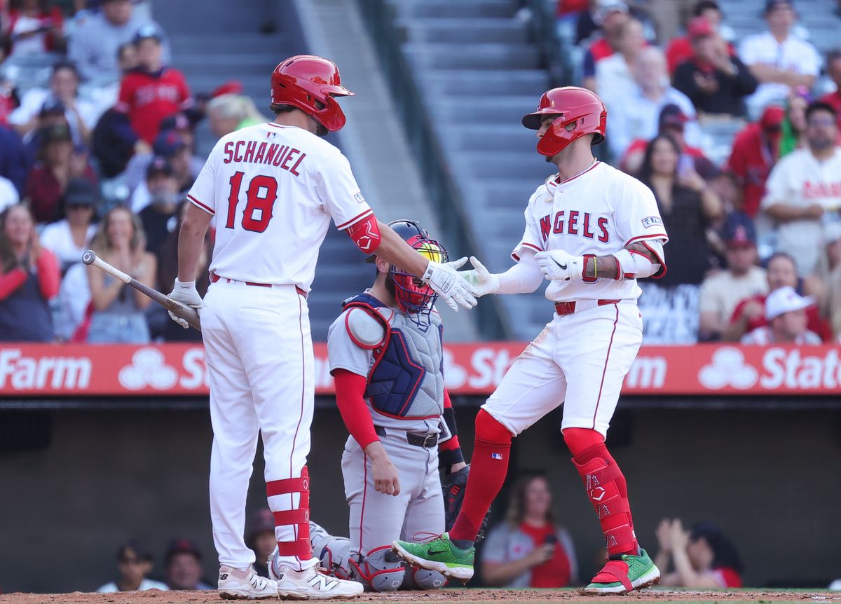 Los Angeles Angels #18 Nolan Schanuel and #9 Zach Neto celebrate a home run at home plate during an MLB game against the Boston Red Sox on June 23, 205 in Anaheim, CA.